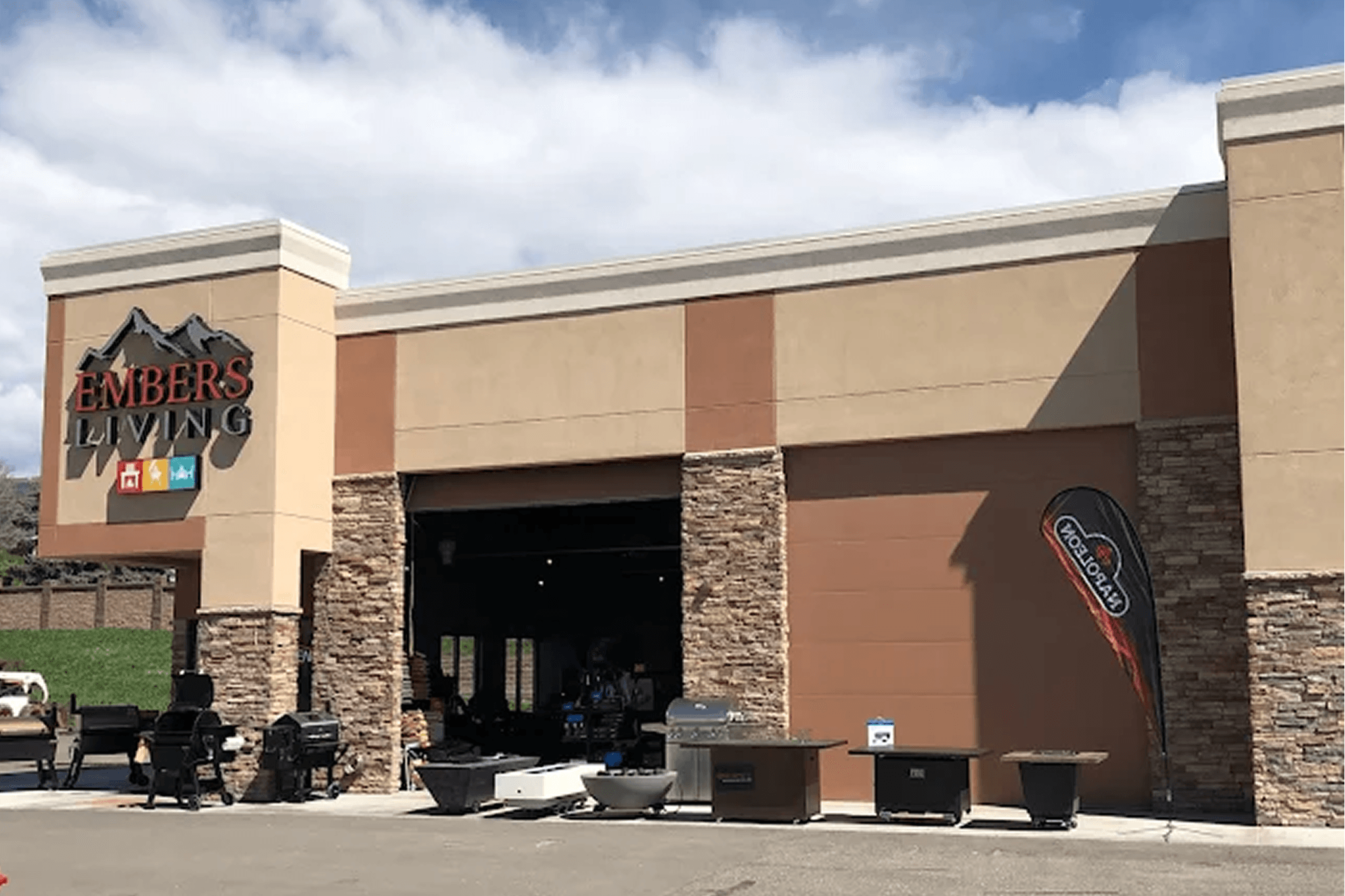 Embers Living storefront with outdoor grills and fire pits displayed outside the showroom.